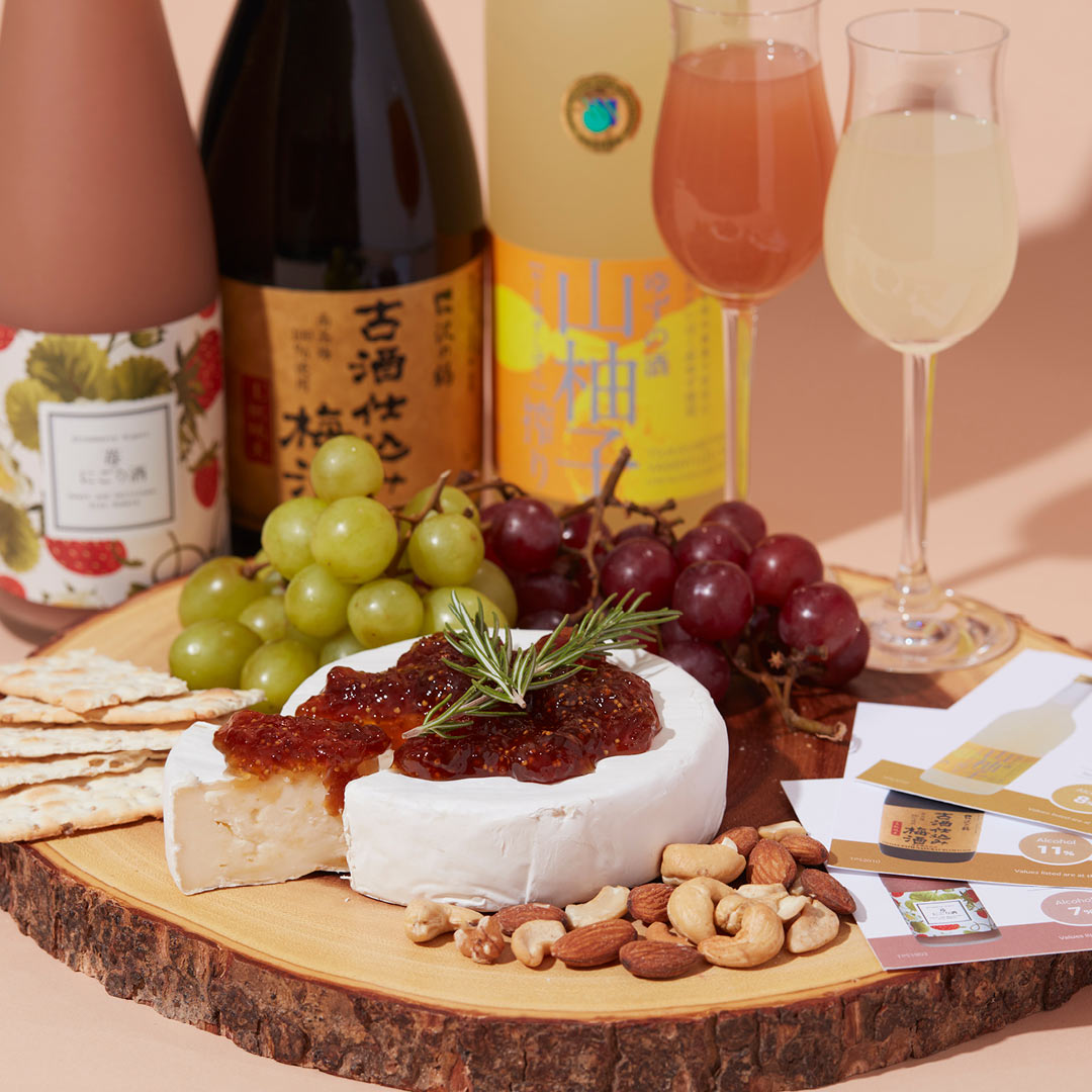 Sawanotsuru “Plum Sake,” Homare “Strawberry” flavored nigori and Tsukasabotan “Yuzu” flavored with dessert glasses, served with brie cheese, grapes and crackers