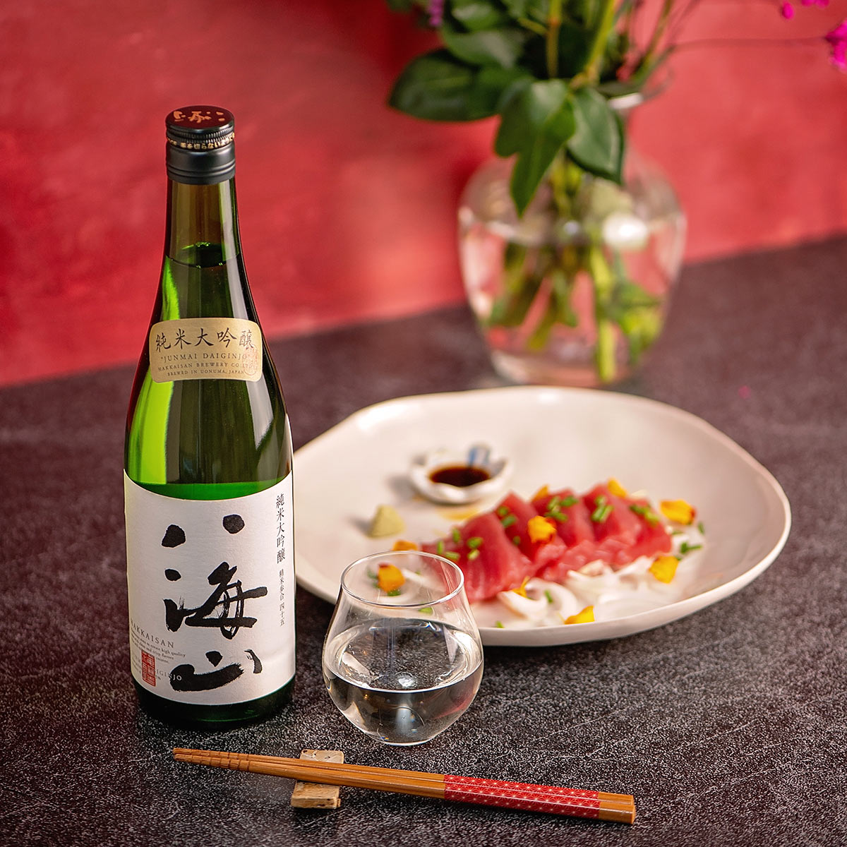 Hakkaisan “Junmai Daiginjo”, with a clear glass cup, served with sashim