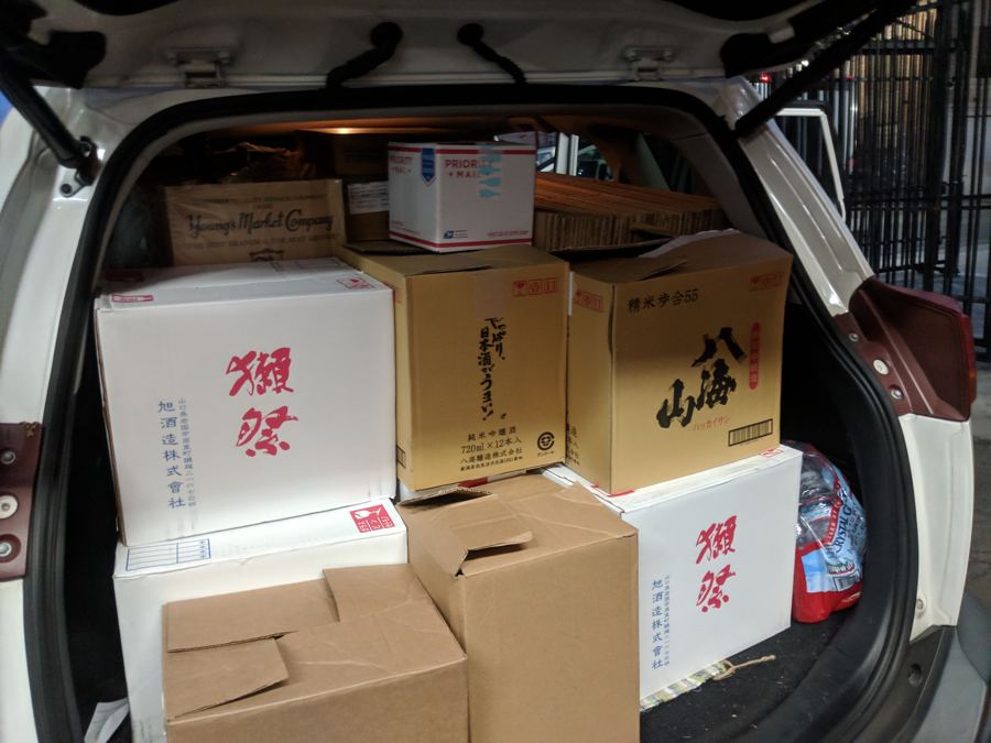 Cases of sake packed into the back of the founder’s car