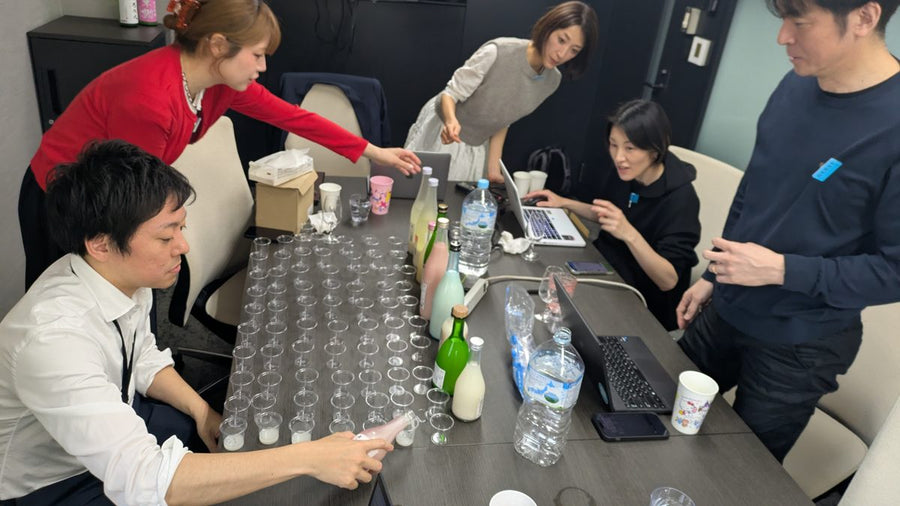 Our sourcing team in Japan tasting a table full of sake samples