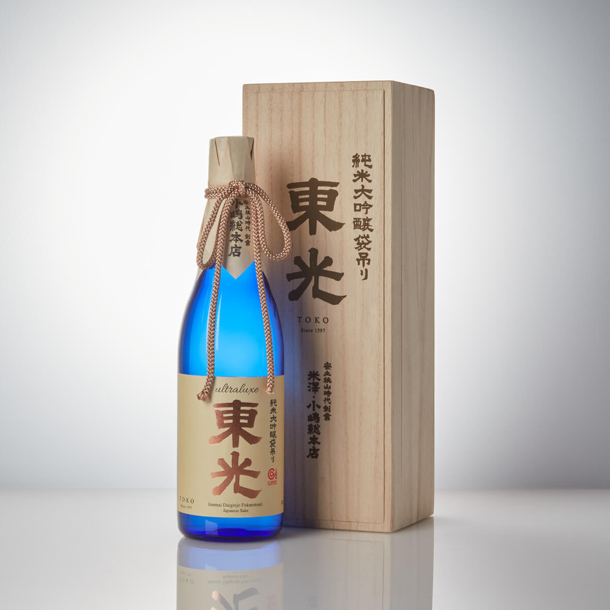 Toko “Ultraluxe” Junmai Daiginjo, standing in front of a product box