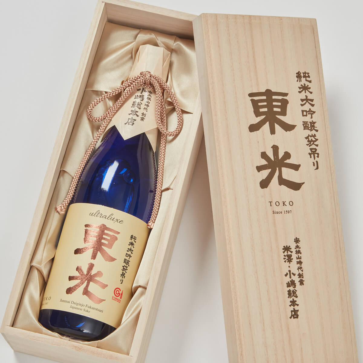 Toko “Ultraluxe” Junmai Daiginjo, lying inside a product box