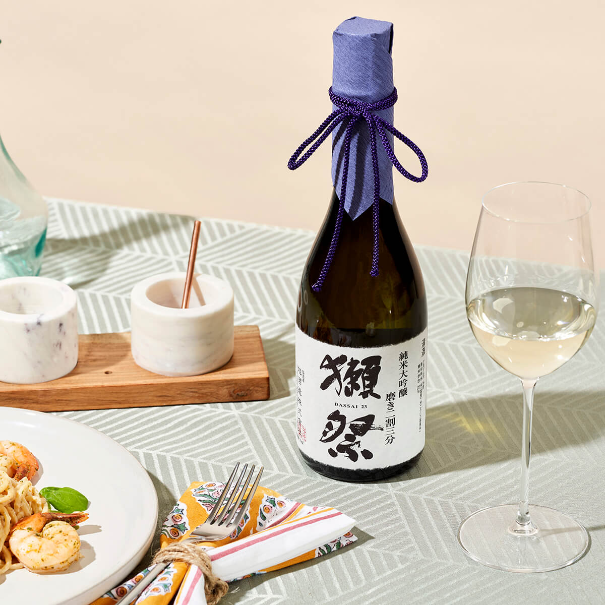 Dassai “23” Junmai Daiginjo with a wine glass, served withcreamy shrimp pasta