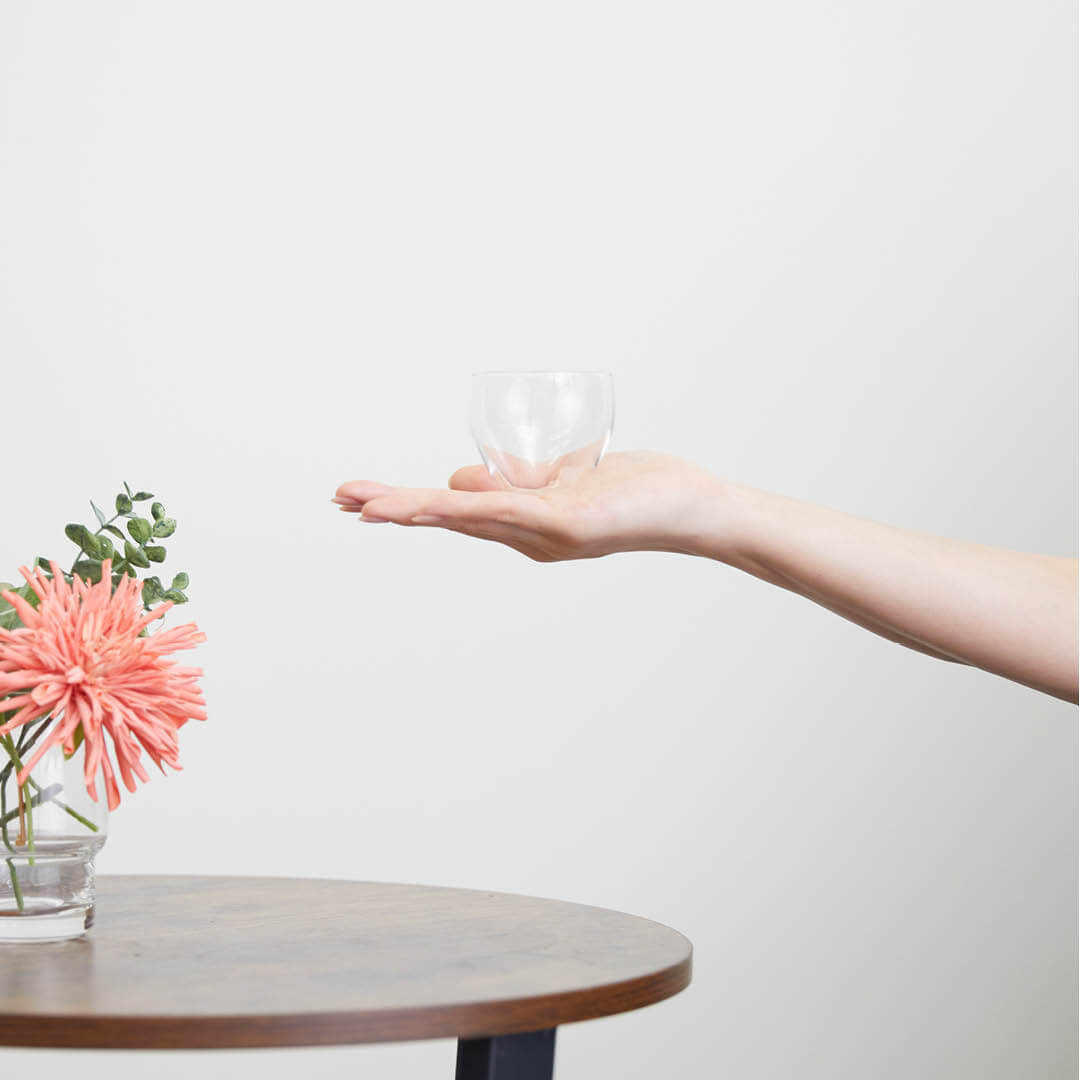 “Aderia” Craft Sake Glass Mellow, on a hand