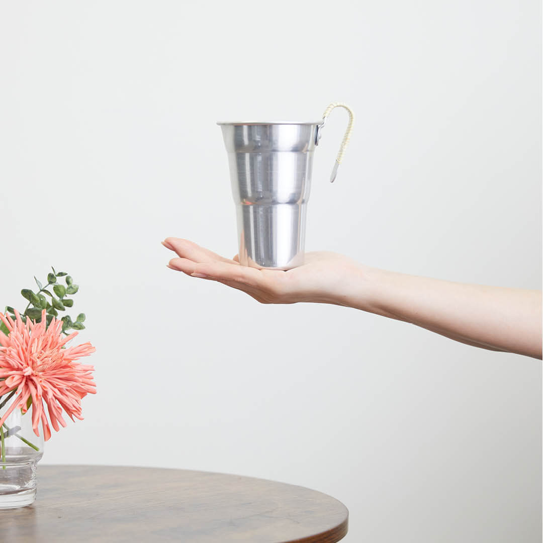 Aluminum Chirori Sake Warmer, on a hand