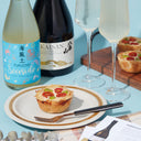 Fukucho “Seaside” Junmai and Hakkaisan “Awa” Clear Sparkling Daiginjo with flute glasses, served with edamame and tomato quiche