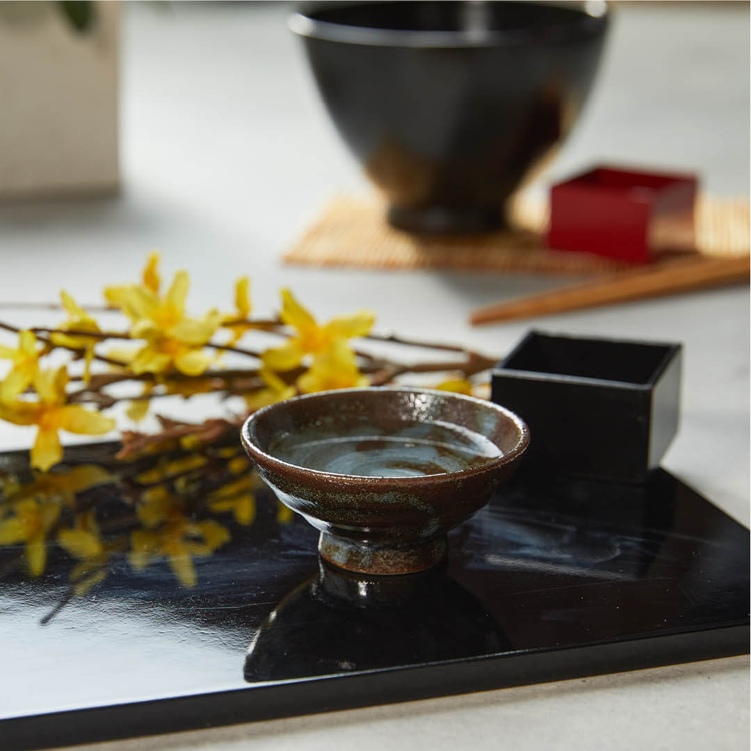 Sorisakazuki Cup With White Swirl, on a table