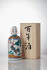 Nishide “100 Year” Junmai Daiginjo, standing in front of a product box Thumbnail