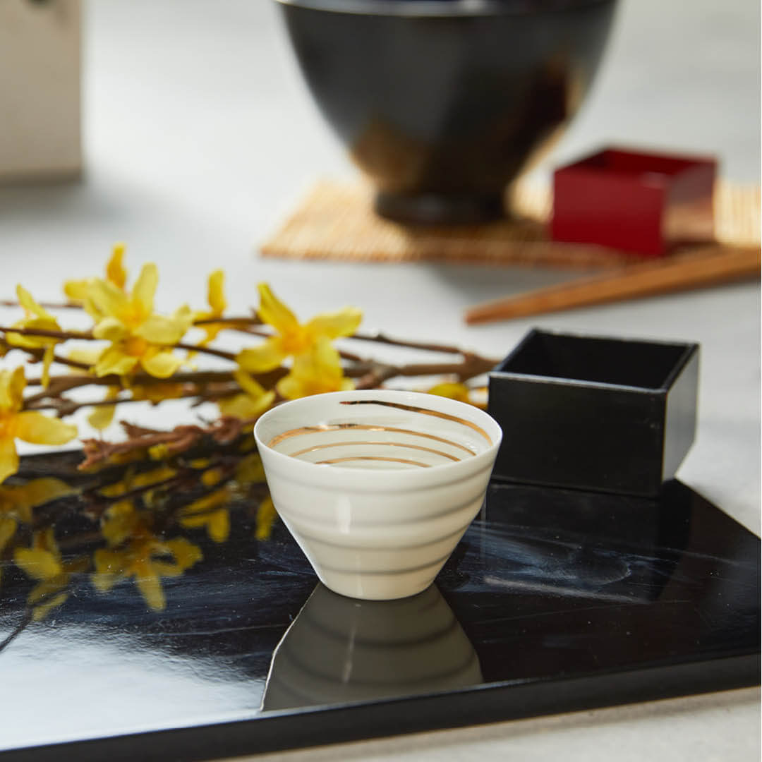 Ultra Thin Cup (Gold and Silver Spiral), on a table