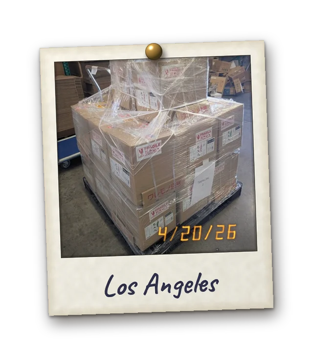 Polaroid: a pallet of Yumiyamaru cases, just unloaded at our warehouse in Los Angeles. Date stamp 4/20/26. Handwritten: Los Angeles